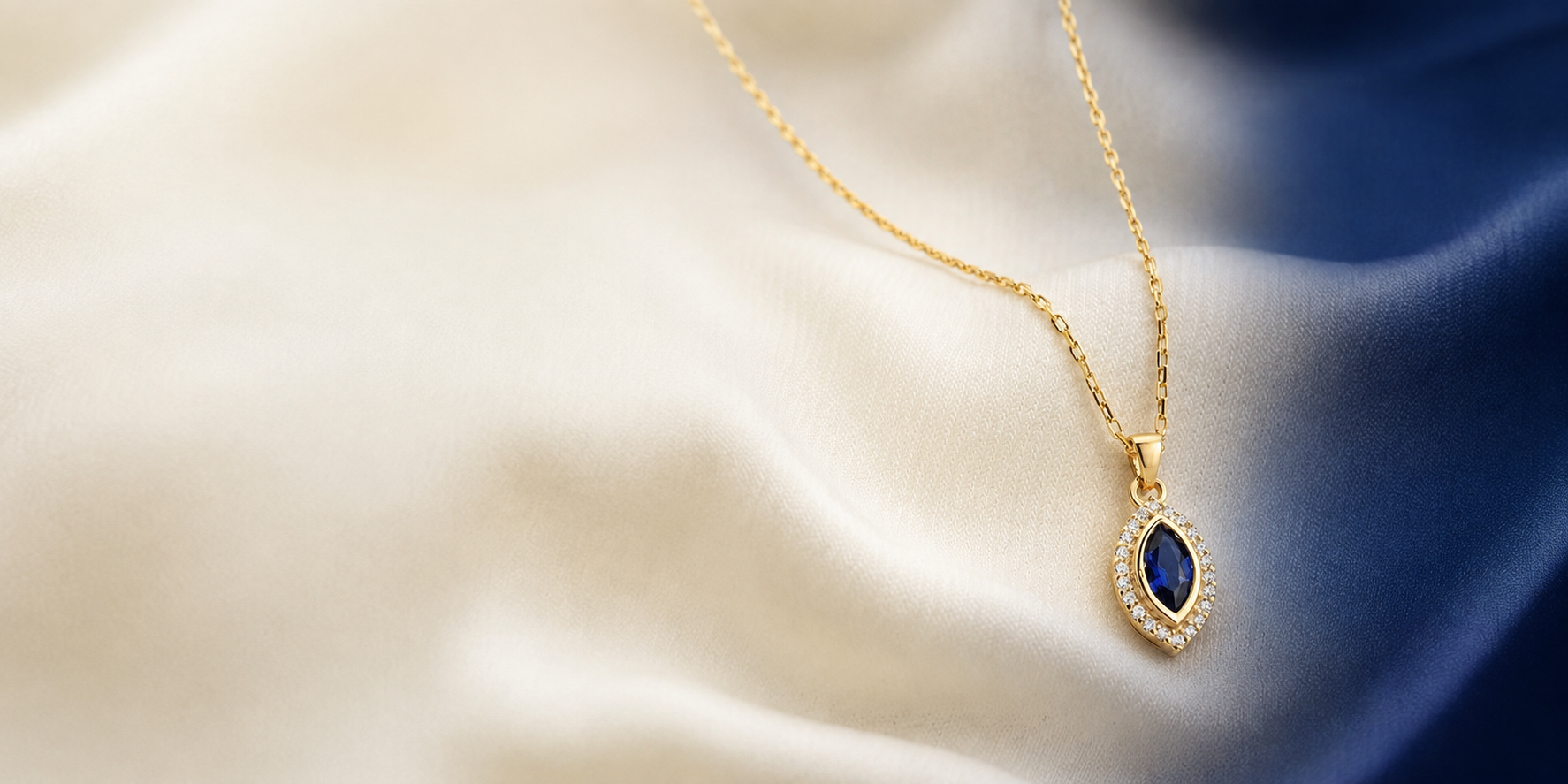 Marquise Sapphire necklace in solid gold with a diamond halo